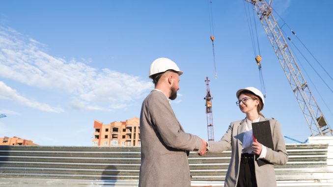 two-professional-engineer-shaking-hand-construction-site_23-2148203963 TRAINING AUDIT DAN EVALUASI PROYEK KONSTRUKSI